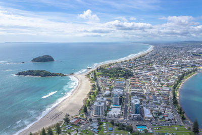 High angle view of sea and city against sky