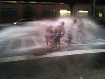 Blurred motion of woman in city at night