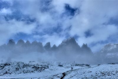 Scenic view of snow covered mountains against sky