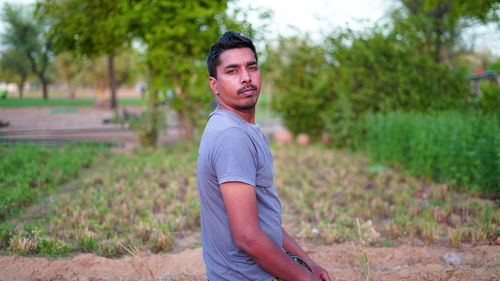 Portrait of young man standing on land