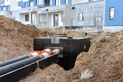 Laying heating pipes in a trench at construction site. install underground storm systems of water 