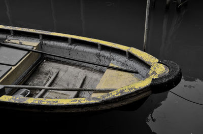 Reflection of old boat moored in lake