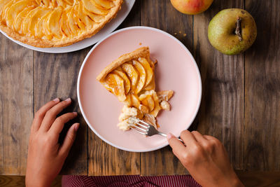 High angle view of person holding food on table