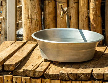  sudan, view of a washroom, metal bowl on a coarse wooden shelf with a water tap 