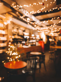 Defocused image of illuminated christmas lights on table