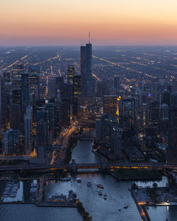 Aerial view of buildings in city at dusk