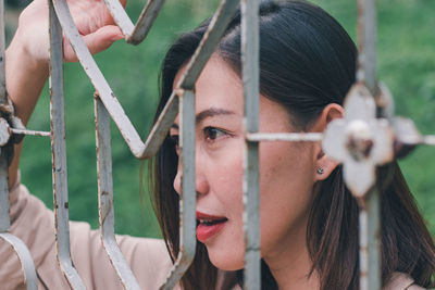 Close-up portrait of young woman looking at camera