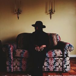 Rear view of woman sitting on table