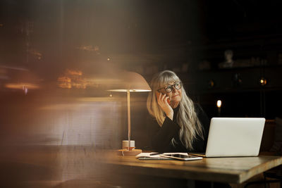 Man using laptop on table at home