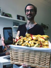 Portrait of man holding basket with chocolates