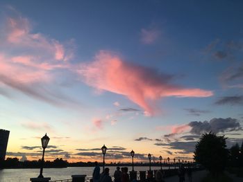 Silhouette street against sky during sunset