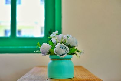 Close-up of flower vase on table at home