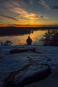 Scenic view of frozen lake against sky during sunset