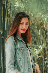 Portrait of smiling young woman standing outdoors