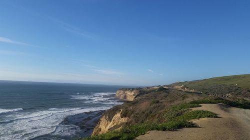 Scenic view of sea against clear blue sky