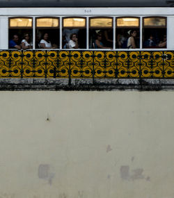 People standing against graffiti wall