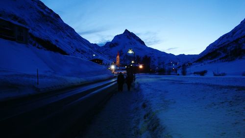 Road passing through snow covered mountains