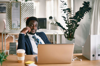 Young woman using laptop while sitting at home