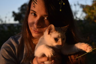 Portrait of young woman with cat