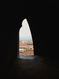 Buildings seen through arch window