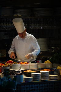 Man preparing food at market stall