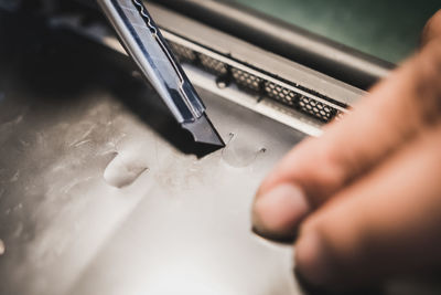 High angle view of person working on metal