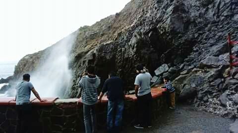 REAR VIEW OF PEOPLE ENJOYING ON WATER