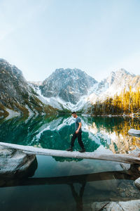 Man standing by lake against sky