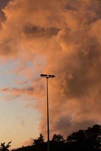 Low angle view of silhouette street light against sky