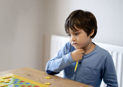 Portrait of boy holding table