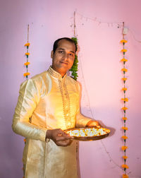 Man holding lighted candles many kept in plat for diwali cultural celebration lightnings