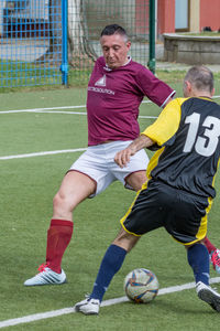 Full length of man playing soccer on field