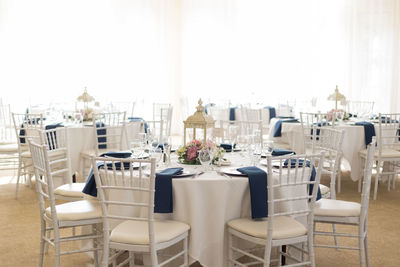 Empty chairs and tables in restaurant during wedding reception