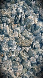 Full frame shot of pebbles in water