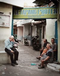 People sitting in front of building