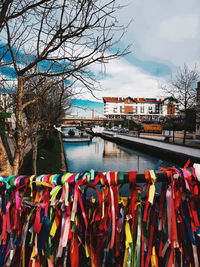 Multi colored umbrellas by building in city against sky