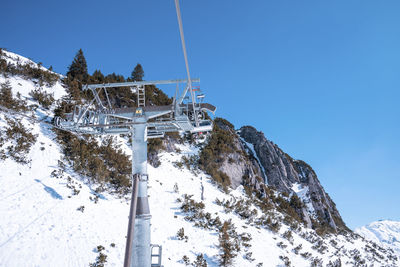 Cable car pulley on snow covered mountain slope