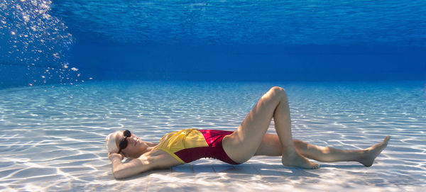 Portrait of young female model posing in pool