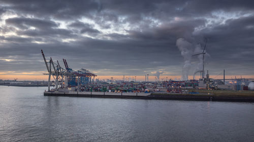 Panorama of a terminal in the port of hamburg by a cloudy sky