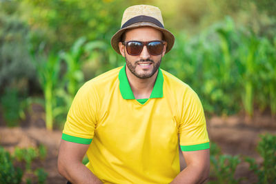 Portrait of young man wearing sunglasses standing outdoors