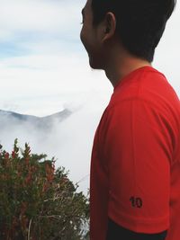 Close-up of man standing against mountain