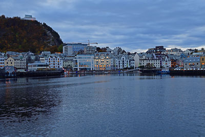 River by buildings in town against sky