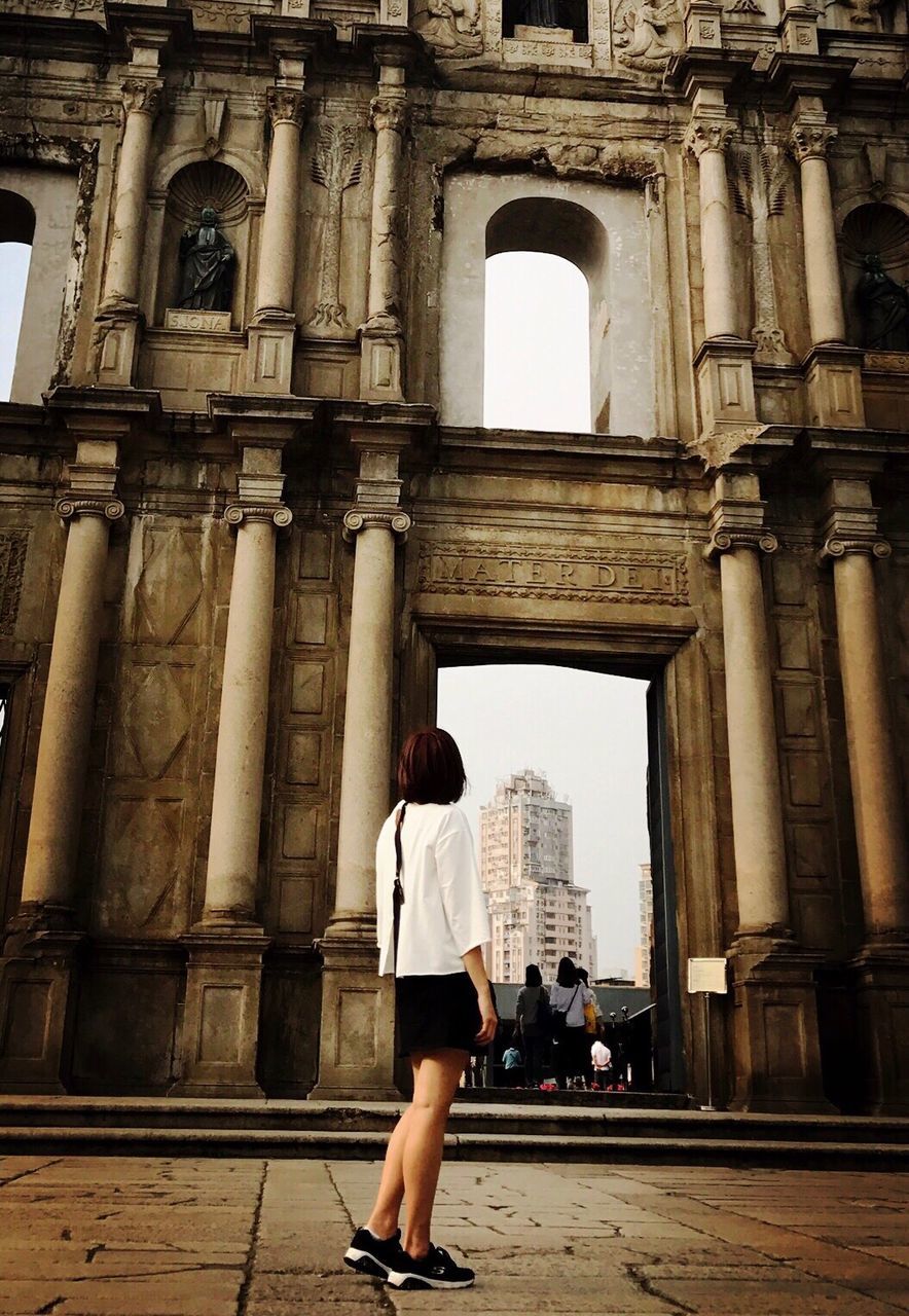 built structure, architecture, city, real people, travel destinations, tourism, tourist, travel, architectural column, building exterior, lifestyles, outdoors, day, history, one person, standing, women, adults only, people, young adult, adult