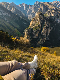 Low section of man relaxing on mountain