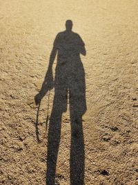 Shadow of man on sand