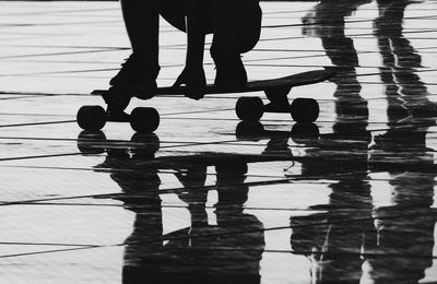 Low section of person skateboarding on footpath
