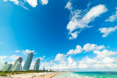 Panoramic view of sea and buildings against sky