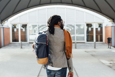 Rear view of women walking on footpath