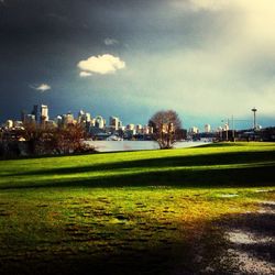 View of grassy field against cloudy sky