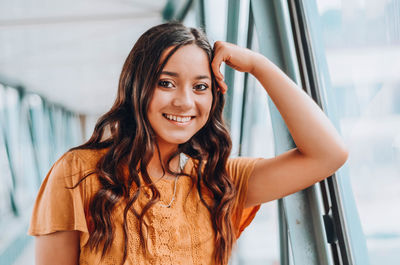 Portrait of smiling young woman on footbridge